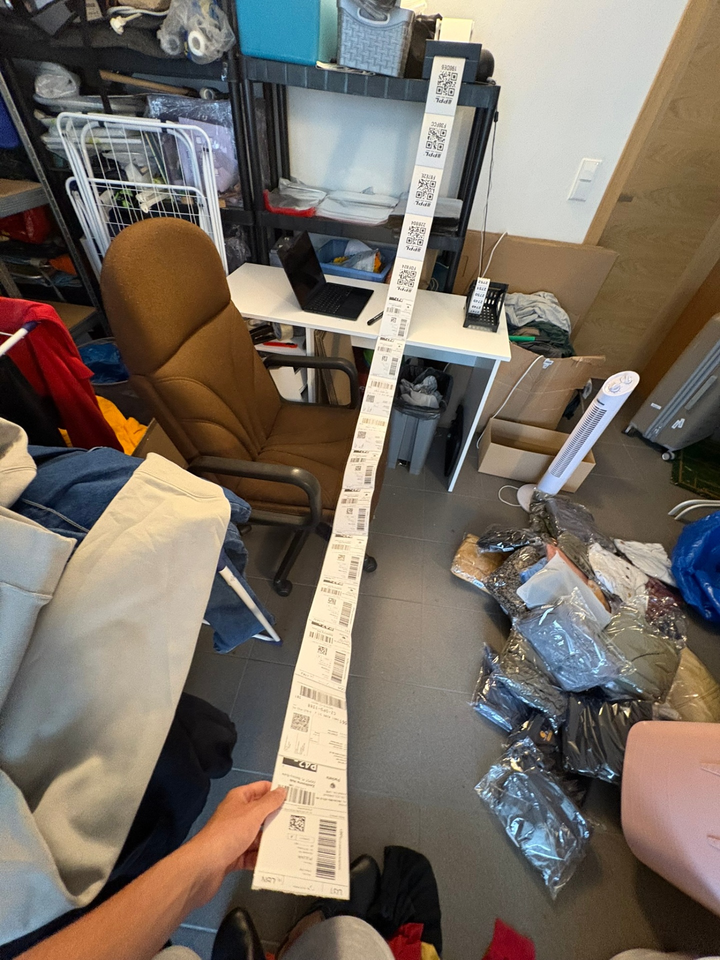 Long roll of printed shipping labels in the packing room
