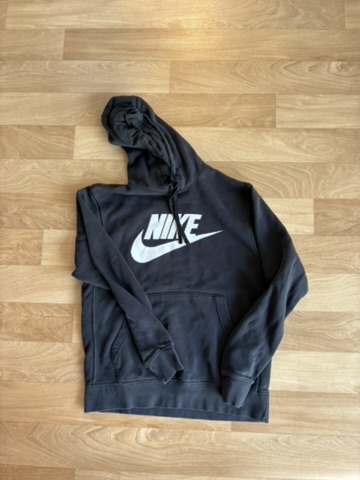 Nike hoodie — bunched on the floor vs. laid out, hood shaped, logo square to camera. — before