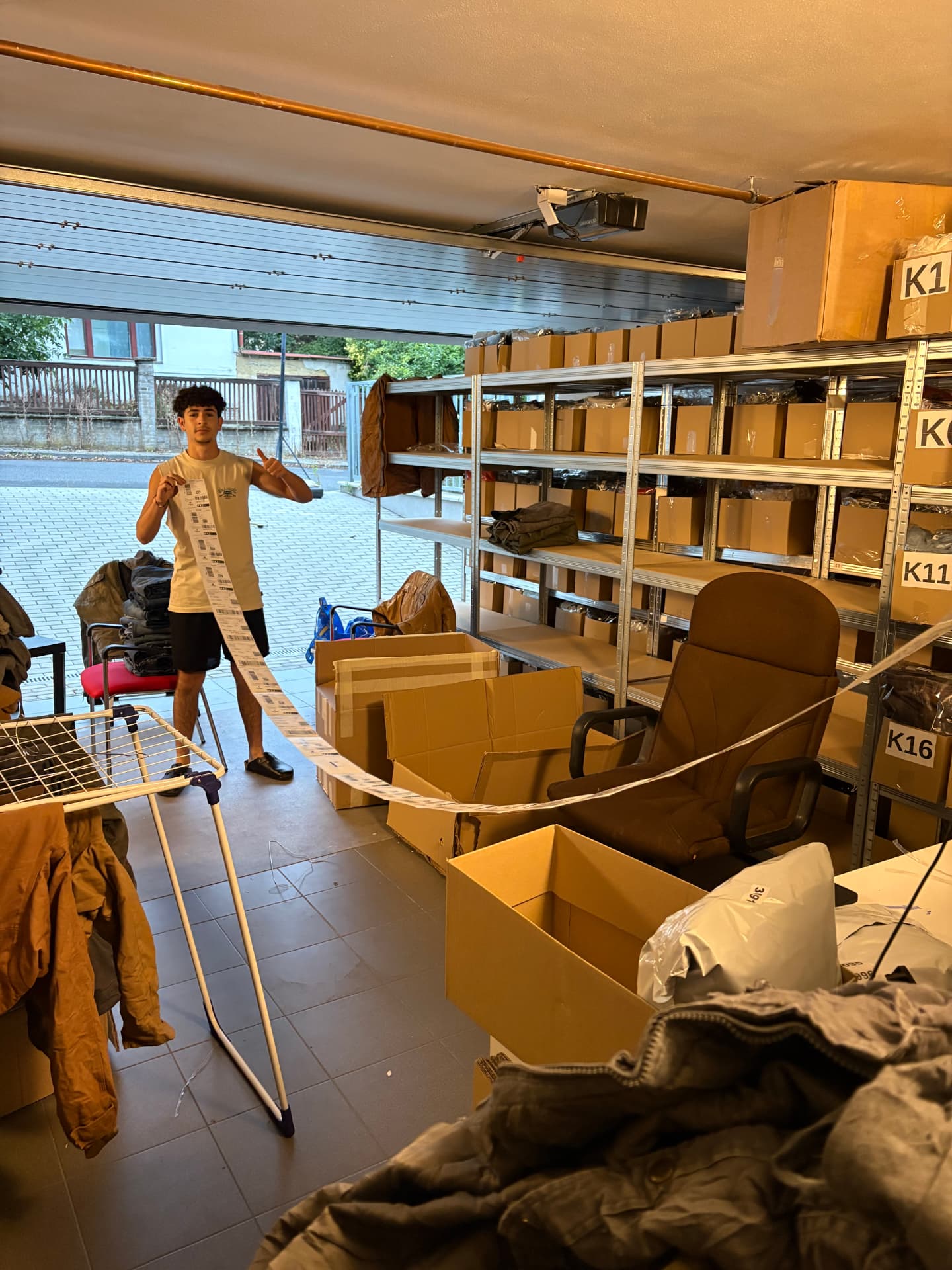 Yuval Yanay preparing orders in his clothing stock and packing room